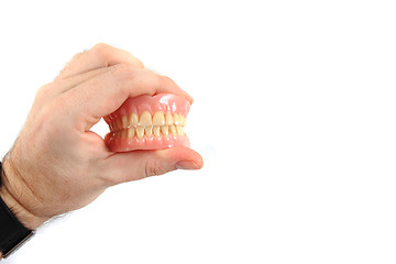 Image showing teeth prosthesis in human hand