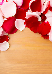 Image showing Rose petal over the wooden background