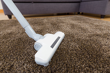 Image showing Cleaning carpet with vacuum 