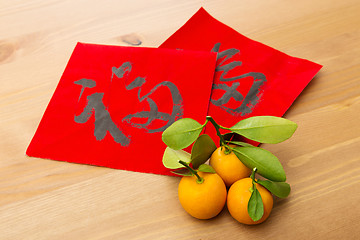 Image showing Chinese new year calligraphy and kumquat, word meaning is good l