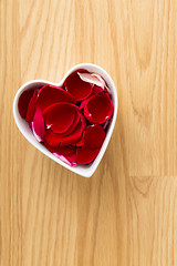 Image showing Rose pedal in heart bowl