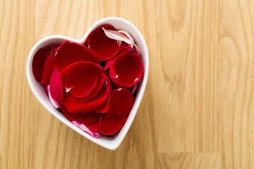 Image showing Rose petal in heart bowl