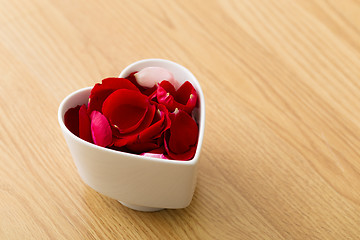 Image showing Rose petal in heart bowl