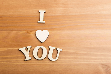 Image showing Wooden letters forming with phrase I Love You and over the woode