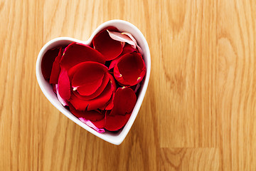 Image showing Rose petal in heart bowl