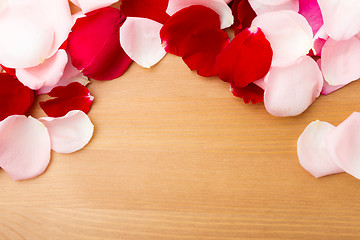 Image showing Rose petal with wooden background