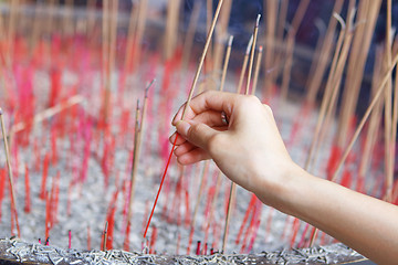 Image showing Offering incense stick to god in Chinese temple