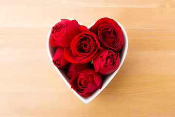 Image showing Red rose inside the heart shape bowl 