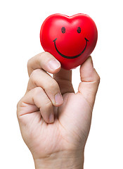 Image showing Hand squeezing stress ball in heart shape