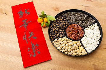 Image showing Lunar new year snack tray and chinese calligraphy, meaning is ha