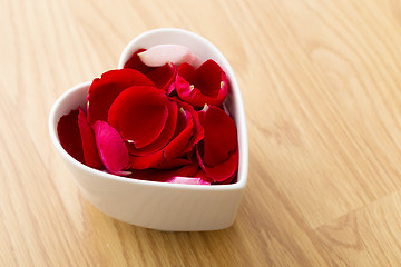 Image showing Rose petal flower in heart bowl