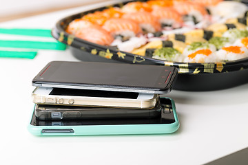 Image showing Mobile phones and sushi