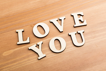 Image showing Wooden texture letters forming with phrase Love You 