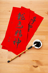 Image showing Writing of Chinese new year calligraphy, phrase meaning is bless
