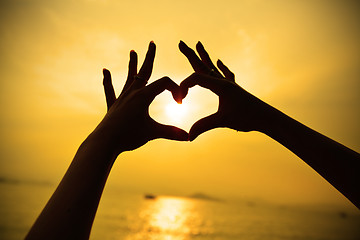 Image showing Silhouette hand in heart shape during sunset