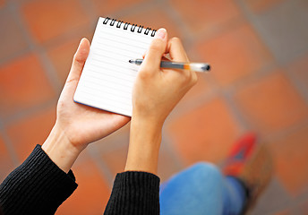 Image showing Woman hand jot note