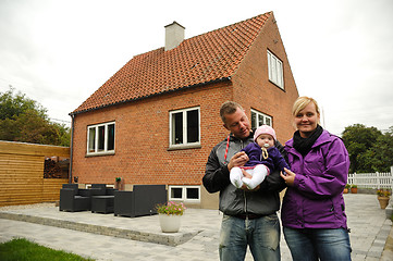 Image showing Happy family in front of house