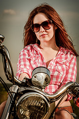 Image showing Biker girl sitting on motorcycle