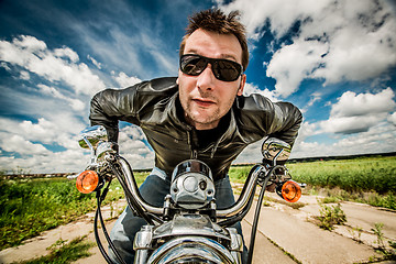 Image showing Biker racing on the road