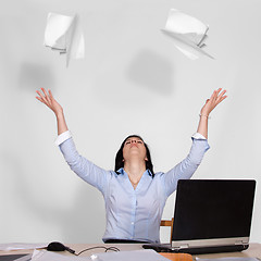 Image showing Woman throws out paper into the air