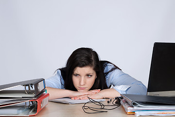 Image showing Young female office worker at desk