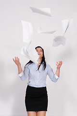 Image showing Woman throws out paper into the air