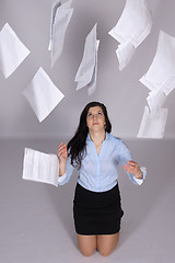 Image showing Woman throws out paper into the air