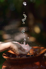 Image showing splashing fresh water on woman hands