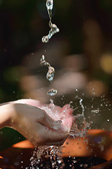 Image showing splashing fresh water on woman hands