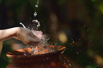 Image showing splashing fresh water on woman hands