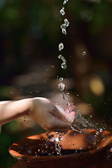 Image showing splashing fresh water on woman hands