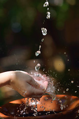 Image showing splashing fresh water on woman hands