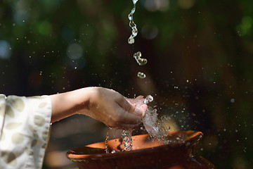 Image showing splashing fresh water on woman hands