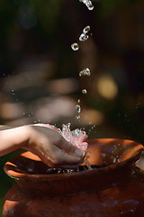 Image showing splashing fresh water on woman hands