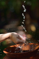 Image showing splashing fresh water on woman hands