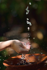 Image showing splashing fresh water on woman hands