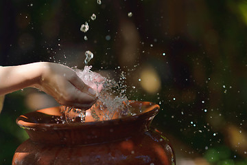 Image showing splashing fresh water on woman hands