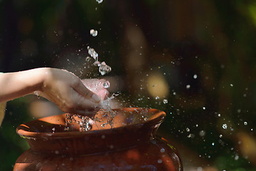 Image showing splashing fresh water on woman hands