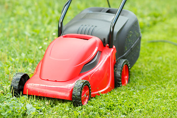 Image showing new lawnmower on green grass