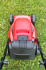 Image showing new lawnmower on green grass