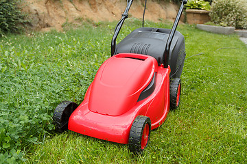 Image showing new lawnmower on green grass