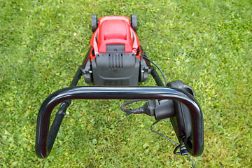 Image showing new lawnmower on green grass