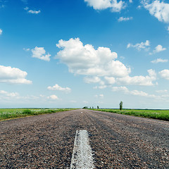 Image showing asphalt road close up under clouds in blue sky
