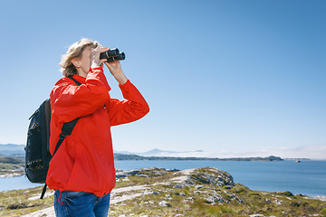 Image showing Woman tourist looking through binoculars