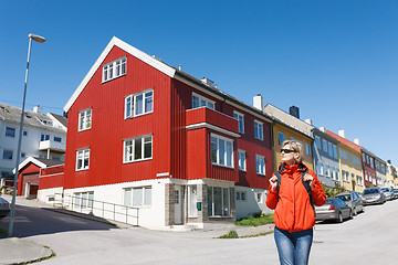 Image showing Tourist standing against multicolored houses