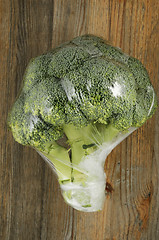 Image showing cabbage broccoli in plastic bag on a wooden background