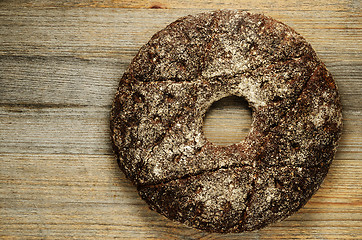 Image showing finnish traditional round bread on a wooden board