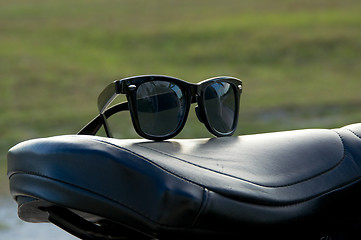 Image showing sunglasses on motorcycle seat