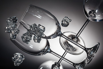 Image showing ice and empty wineglasses on color background