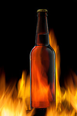 Image showing Beer bottle in fire on black